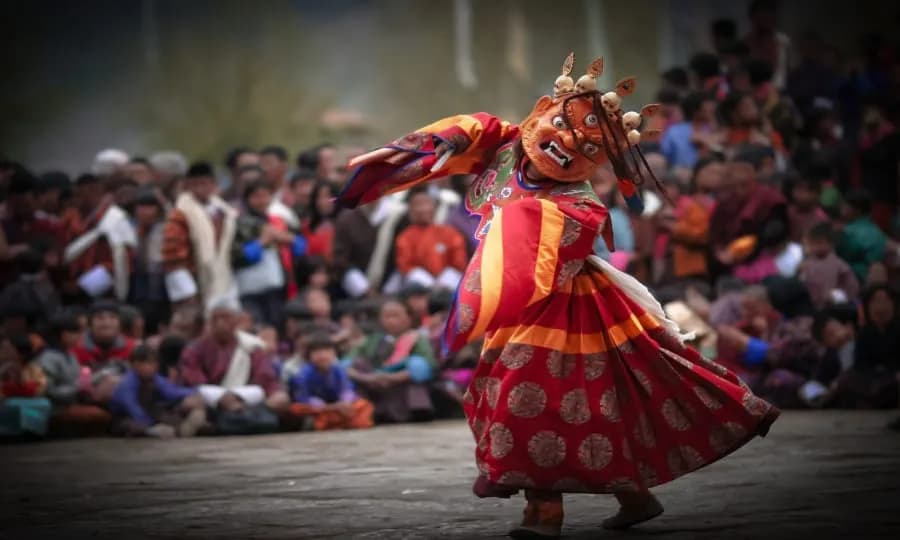 Masked dancer performing at a Bhutanese festival