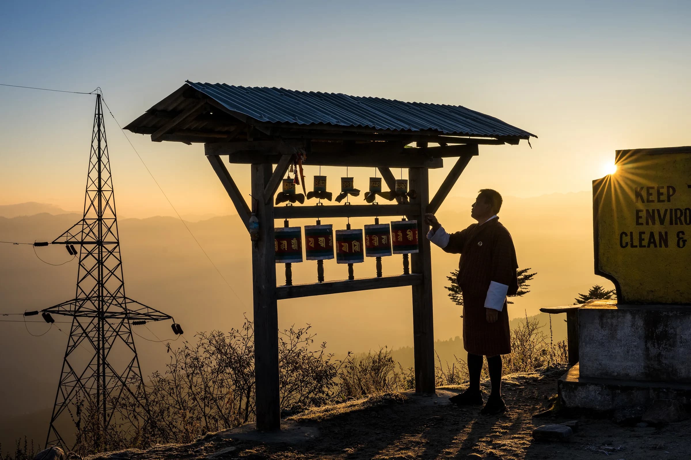 A local Bhutanese guide at a mountain pass at sunrise